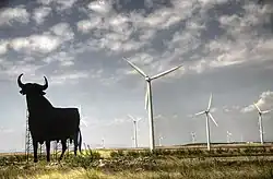 Image 24Wind turbines are typically installed in windy locations. In the image, wind power generators in Spain, near an Osborne bull. (from Wind power)