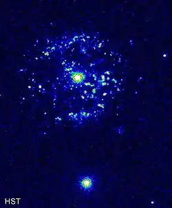 An image of a central white object surrounded by white and pale blue markers signifying material in a shell-like pattern around it