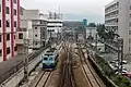 A locomotive heading towards a reversing siding. Lo Wu station in the background (January 2019)