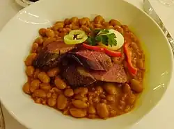 Cholent, a stew of beans topped with smoked goose