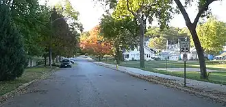 Street with trees on left, small park on right