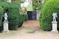 Two pairs of cherubs to north-west of the Grand Basin in Melbourne Hall gardens