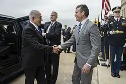 Two men in suits giving a handshake