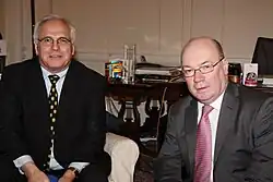 Two men seated in suits