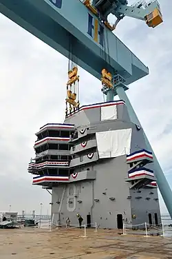 The 555-metric-ton (546-long-ton) island in place after being lifted into position on the ship's flight deck during a ceremony at Newport News Shipbuilding in January 2013.