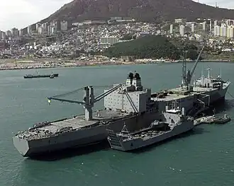 LSV alongside USNS Pollux (T-AKR-290) in the port of Pusan, South Korea. Pollux is loading vehicles onto the LSV which will then transport them to shore.