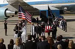 Honor and color guards carry the casket of former president Ronald Reagan after it is removed from the Boeing VC-25 Special Air Mission (SAM) 28000 in California.