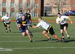 Photograph of men playing flag football