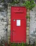A close-up of the postbox set into a wall on the property