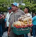Street vendor in Maracaibo with improvised carry container