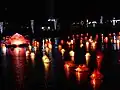 Floating lanterns float along a lake during Vesak in Sri Lanka
