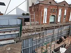 View of the western end of the warehouse, with a corner of Factory International in the background, 2023