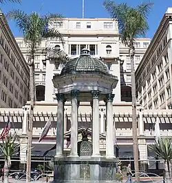 Oval, black and white shoulder-height portrait of a man in his forties or fifties, slightly balding wearing a suit