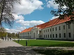 Long, two-story building with a red roof