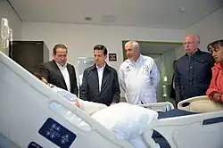 Eruviel Ávila Villegas (far left) and Enrique Peña Nieto visiting an injured person