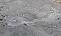 A bubble of gas bursting through the mouth of a Mud Volcano