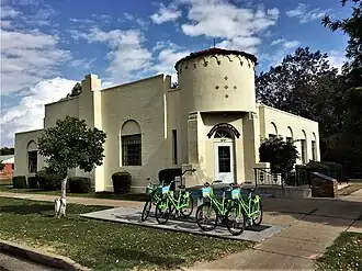White brick one-story building with a castle-like turret
