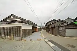 Wooden and black tile-roofed ship-owner houses.