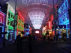 Main Street's buildings and roof illuminated by Christmas lights.