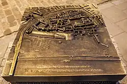 A bronze die-cast model of the early Old Town on display outdoors