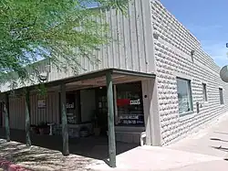 The Wickenburg Drug Company first occupied this building, built in 1918, at the corner of Apache and Frontier Streets in Wickenburg, Arizona. It was followed by Jones’ Pharmacy. This building with its molded cement blocks housed Valley National Bank/ Bank One from 1946-1995. It is listed as historical by the Wickenburg Chamber of Commerce Wickenburg.