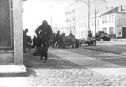 German tanks and motorized infantry on Grójecka str. between Siewierska str. and Przemyska str. PzKpfw I tank and a 7.5 cm le.IG 18 gun are visible.