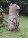 Wooden bear sculpture in the woods