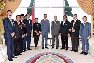Jokowi with Mahathir Mohamad, accompanied by several government ministers from both countries