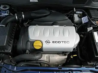 An engine made by Opel with the model number X18XE1. There is ECOTEC inscribed on the top of the engine.