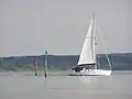 A yacht entering the river from the Solent