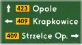 E-2a "signpost board placed next to the carriageway" (Advanced direction sign; stack type)