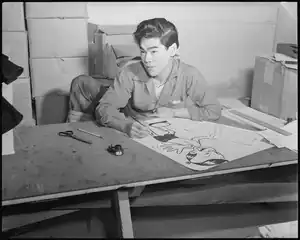 Topaz, Utah. Bennie Nobori, former animator in a Hollywood film studio, is now a cartoonist on the . . . - NARA - 536983